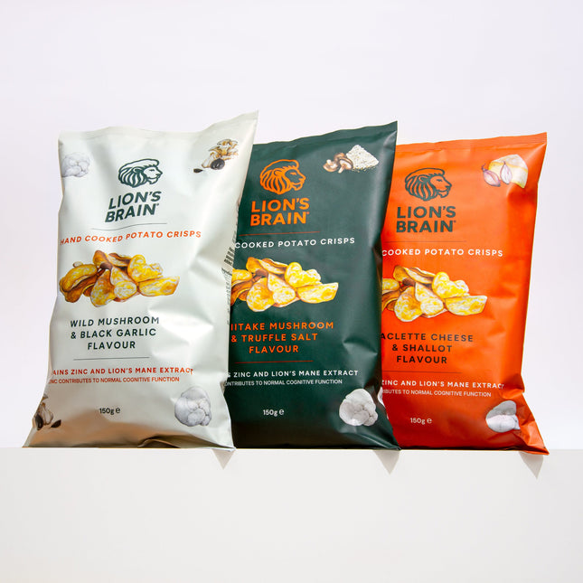 Three bags of Lion's Brain hand cooked potato crisps in different flavours: Wild Mushroom & Black Garlic, Shiitake Mushroom & Truffle Salt, and Raclette Cheese & Shallot Flavour. The bags are cream, dark green, and orange respectively, set against a clean white background.