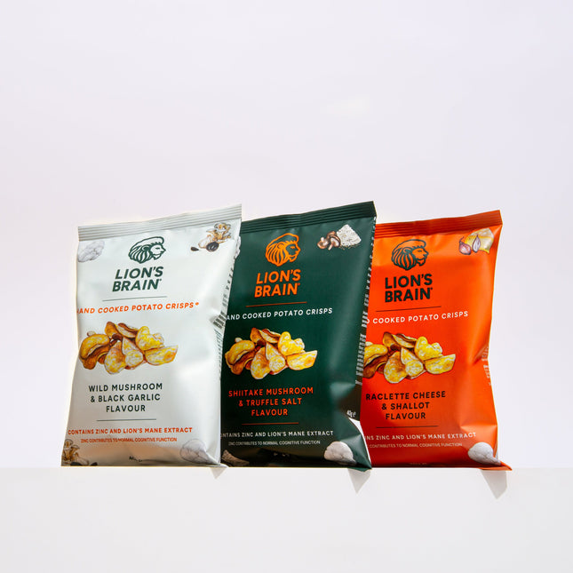 Three bags of Lion's Brain potato chips in different flavors (Wild Mushroom & Black Garlic, Butter Mushroom & Rosemary, and Beetette Cheese & Shallot) lined up on a white surface against a white background.